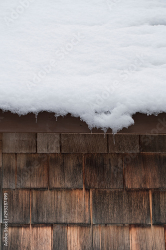 Snow on a roof with cedar shinges photo