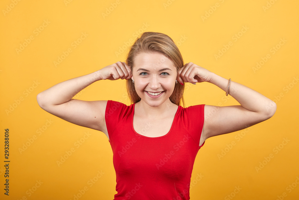 young blonde girl in red t-shirt over isolated orange background shows emotions young blonde girl in red t-shirt over isolated orange background shows emotions