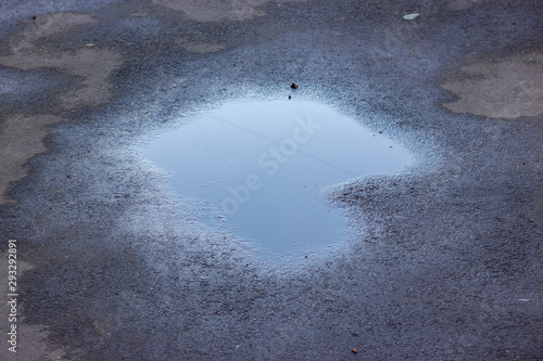 Canvas Print Drops of rain water on a fresh asphalt in the sun.