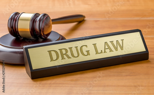 A gavel and a name plate with the engraving Drug law photo