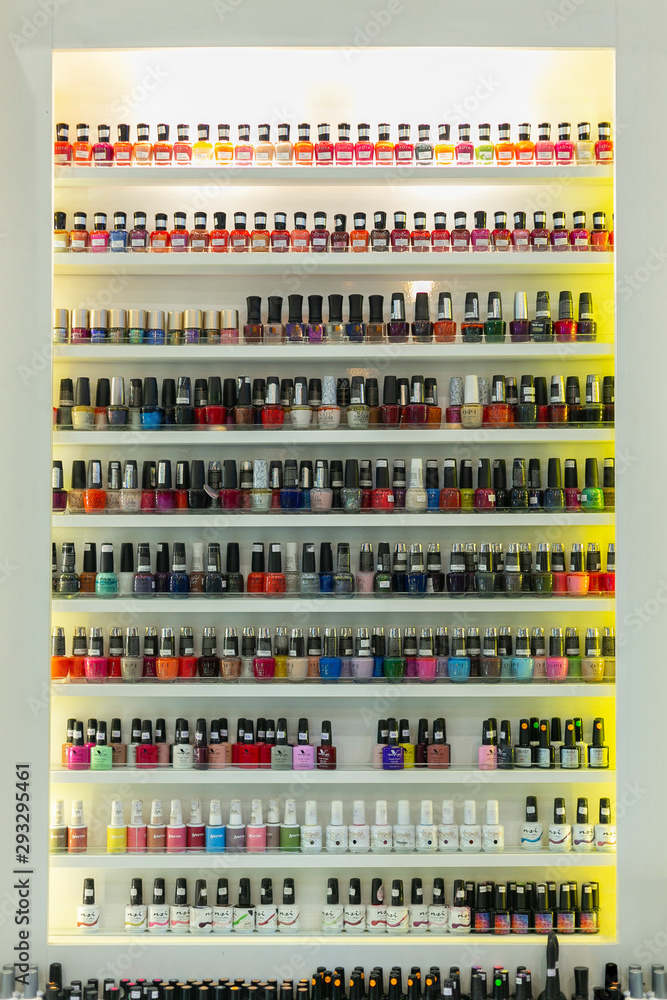 Fototapeta premium NAKHONRATCHASIMA, THAILAND SEP 01, 2019: Set of different nail varnishes on shelves in cosmetic store.