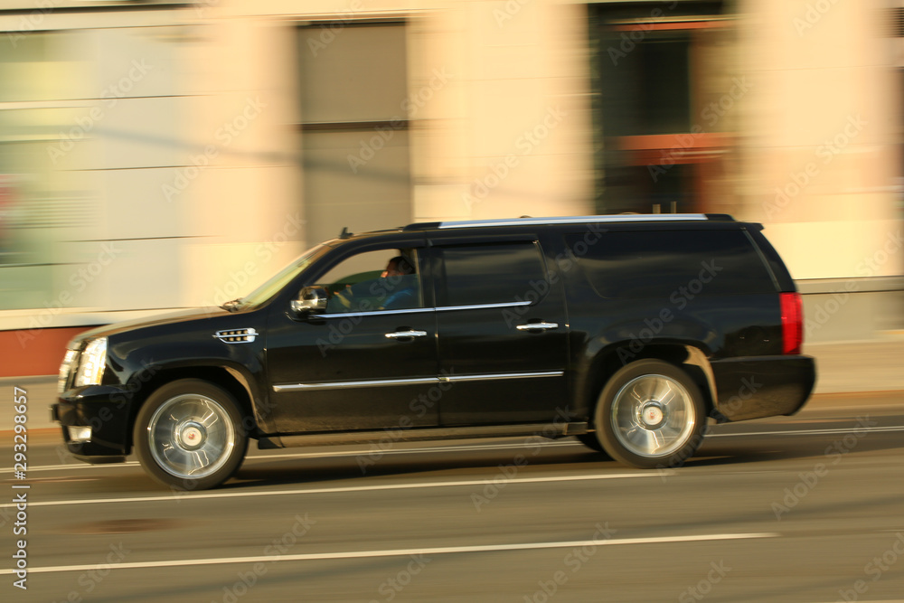 dark car in motion around the city. blur