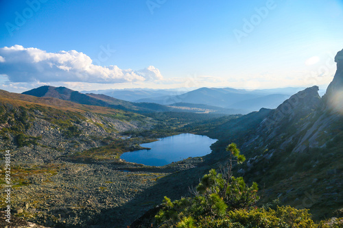 mountain landscape with distant forest and lake 