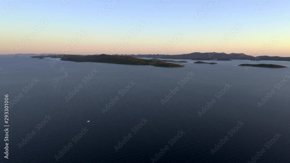 A boat is sailing on the sea during sunset in Croatia near Dugi Otok. A boat is sailing on the sea during sunset in Croatia near Dugi Otok.
