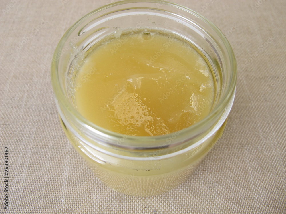 A jar of with light yellow linden flowers honey A jar of with light yellow linden flowers honey