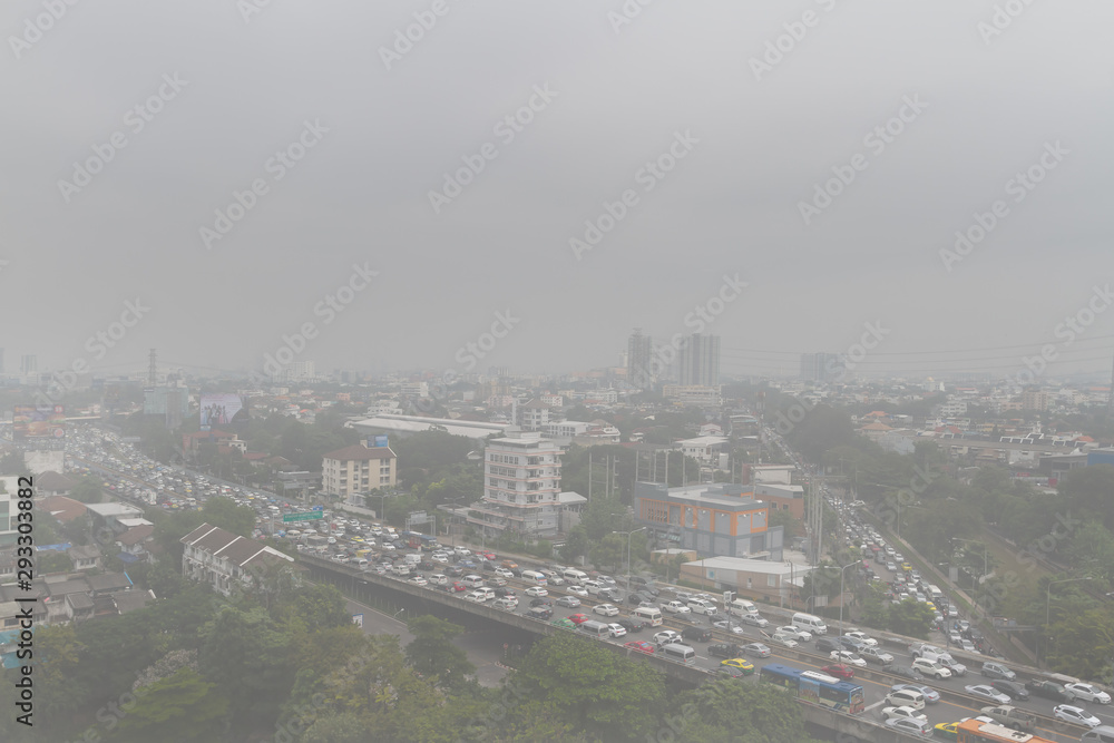BANGKOK, THAILAND – Sep 25, 2019: Many vehicles slow driving on the express way and traffic jam on the road with smoke or foggy around area. Background for pollution or micro dust PM 2.5 concept.