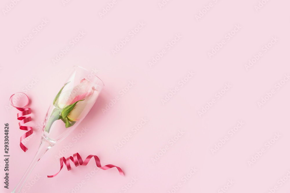 Rose buds in wineglasses on a pink background.  Background for holiday, birthday, wedding, Valentine's day, Women's Day. Top view, flat lay composition. Copy space for text or design.