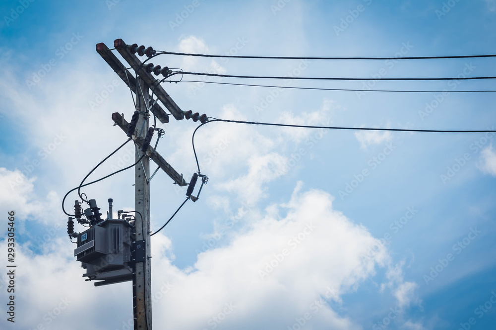 Electric tranformer on the eletric Cement-pole. White clouds and blue sky Electric tranformer on the eletric Cement-pole. White clouds and blue sky