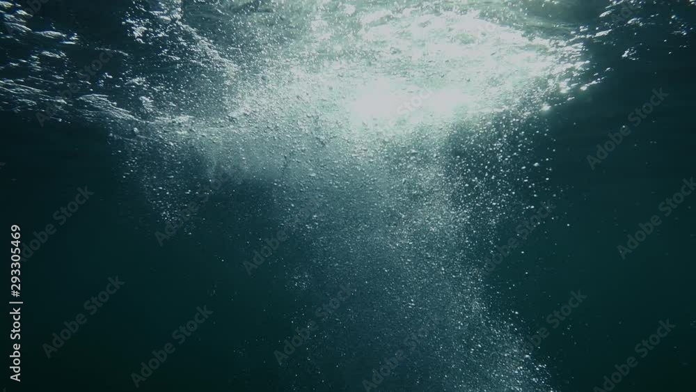 Bubbles rise from the depth to the surface in slow motion. They turbulize and dissolve in water. They pass close to the camera and propagate in defocus. Bubbles rise from the depth to the surface in slow motion. They turbulize and dissolve in water. They pass close to the camera and propagate in defocus.