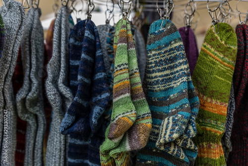 colors of knited sox hanging on a stand on an autumn fair