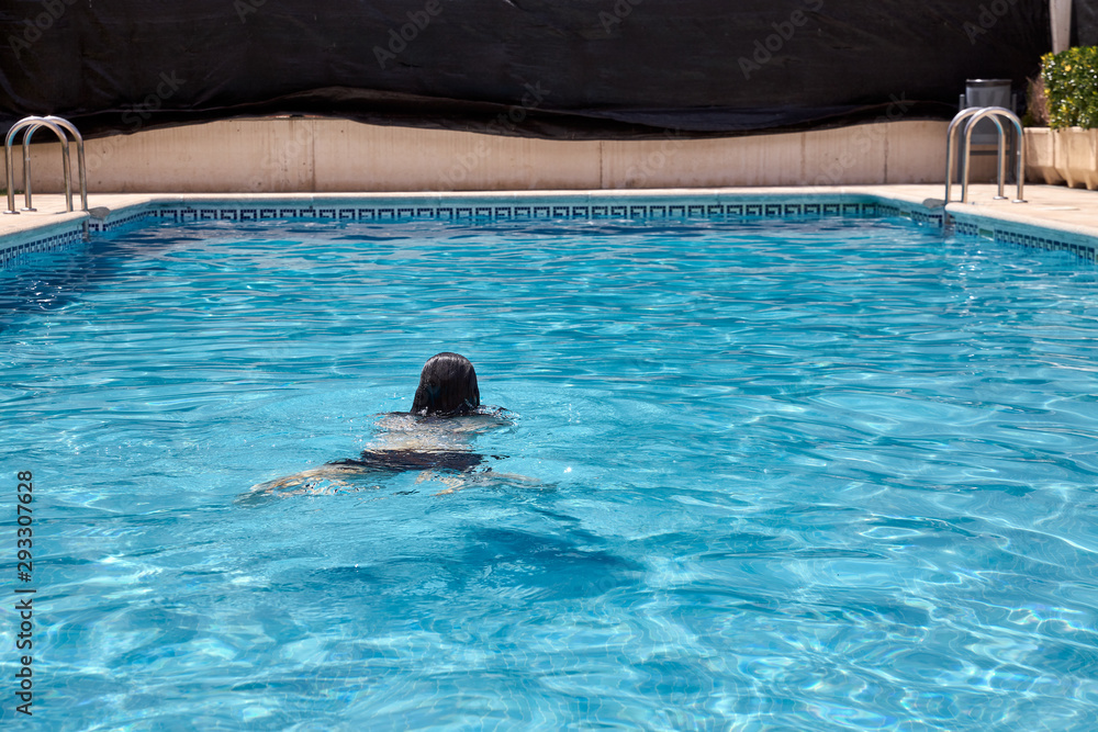 woman swimming in a pool woman swimming in a pool
