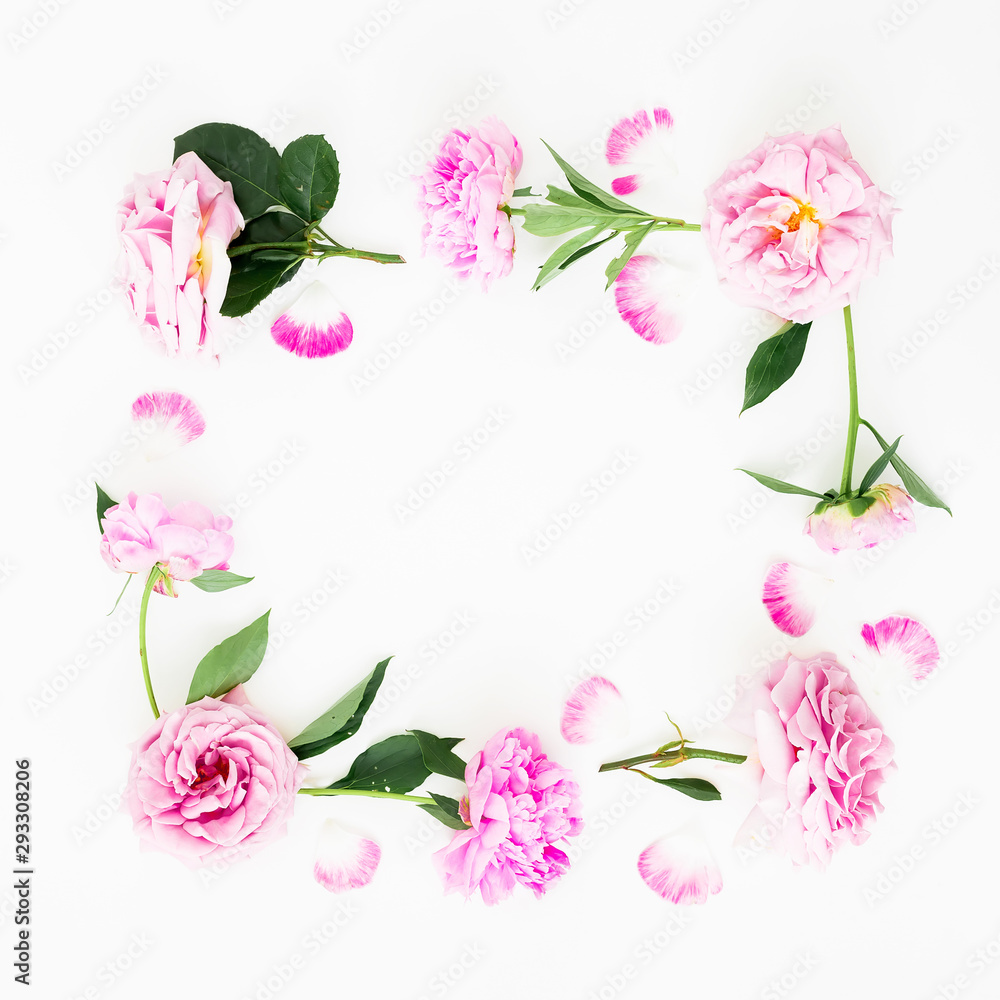 Frame of pink peonies flowers, roses and leaves on white background. Flat lay