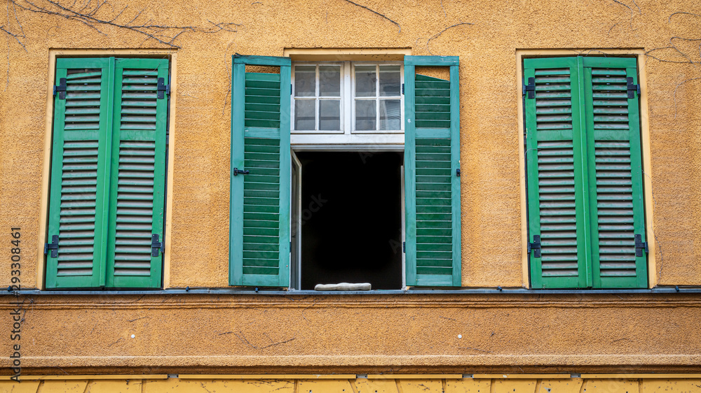 Fototapeta premium Old town house facade with the green shutters