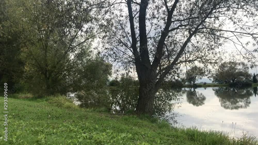 Beautiful fish pond near Badin, Banska Bystrica, Slovakia. Fishing place. Clouds over the lake. Mirror reflection in standing water. Beautiful fish pond near Badin, Banska Bystrica, Slovakia. Fishing place. Clouds over the lake. Mirror reflection in standing water.