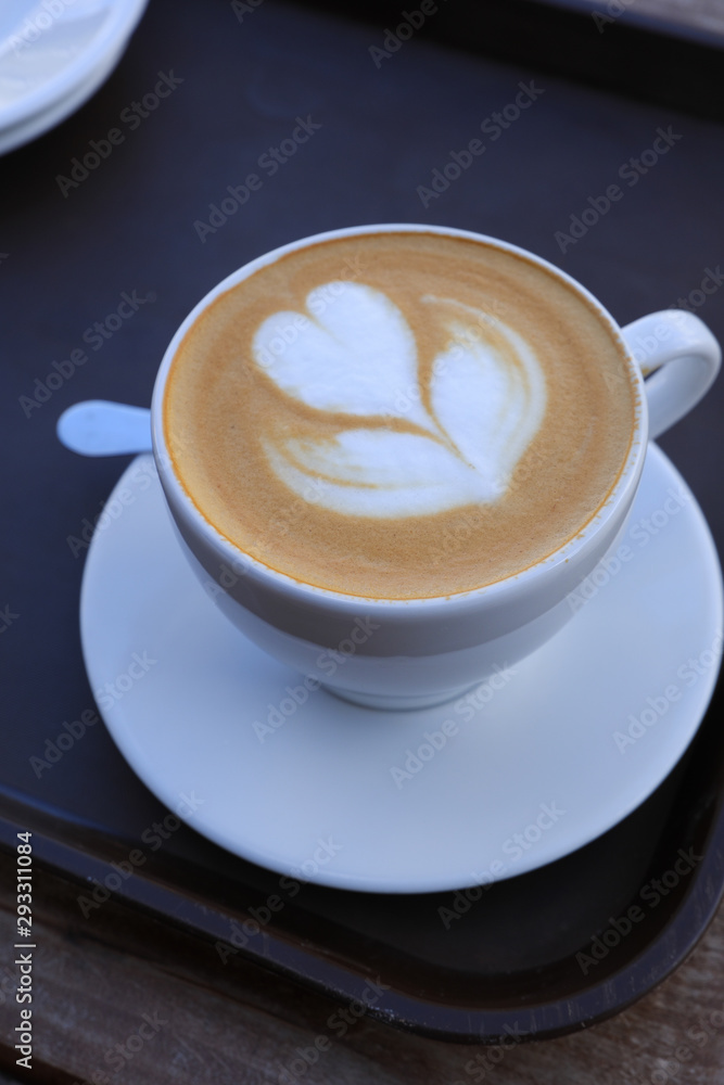 Hot cappuccino one cup with cookie on the wooden table ware