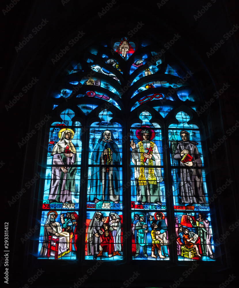 a detailed view of a stained glass window in the Basilica de Saint-Sauveur in Dinan in Brittany