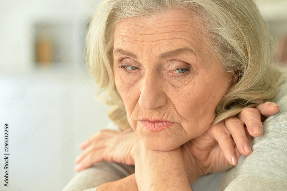Portrait of sad senior woman at home with phone Portrait of sad senior woman at home with phone