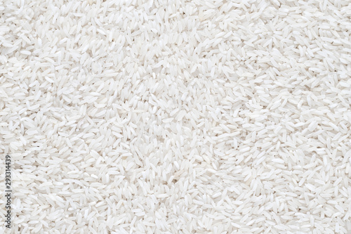 Heap of raw rice. Uncooked white rice, texture. Food background. Top view.