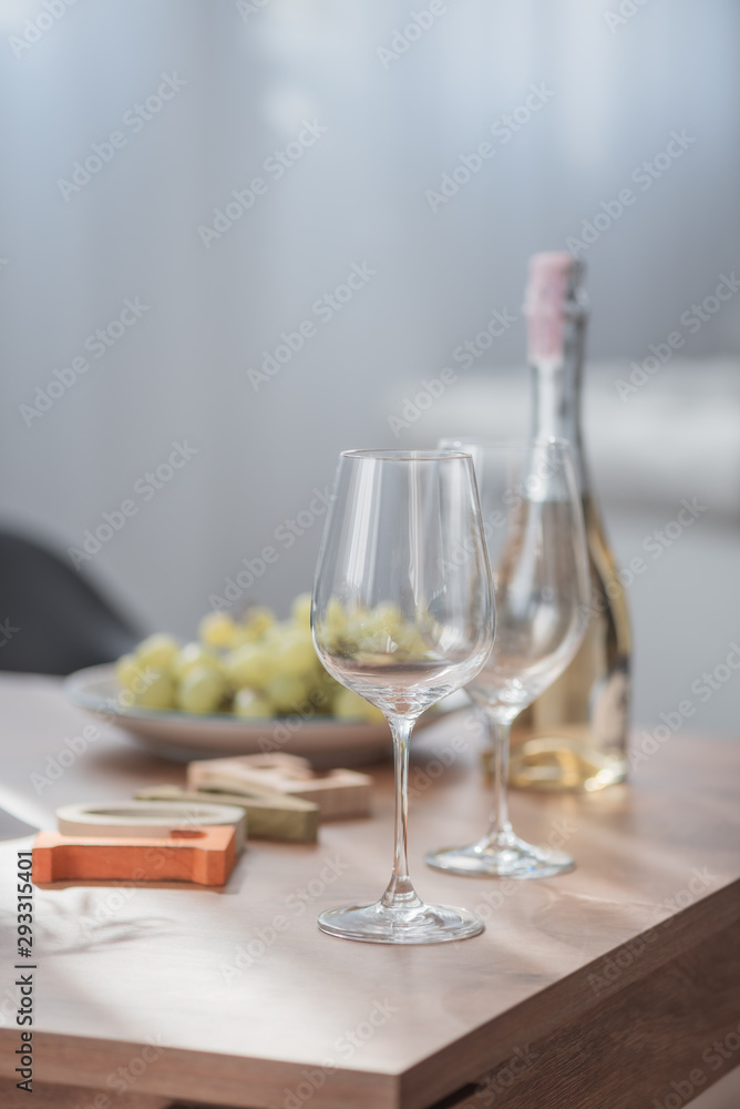 Wine glass, grape and wine bottle on wood table Wine glass, grape and wine bottle on wood table