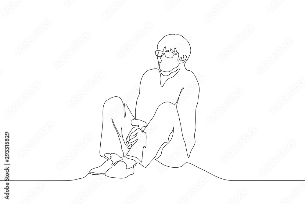 A continuous line of art man with glasses sits alone on the floor, clenching his shoulders and holding his hands together between his legs. The concept of loneliness. Can be used for animation