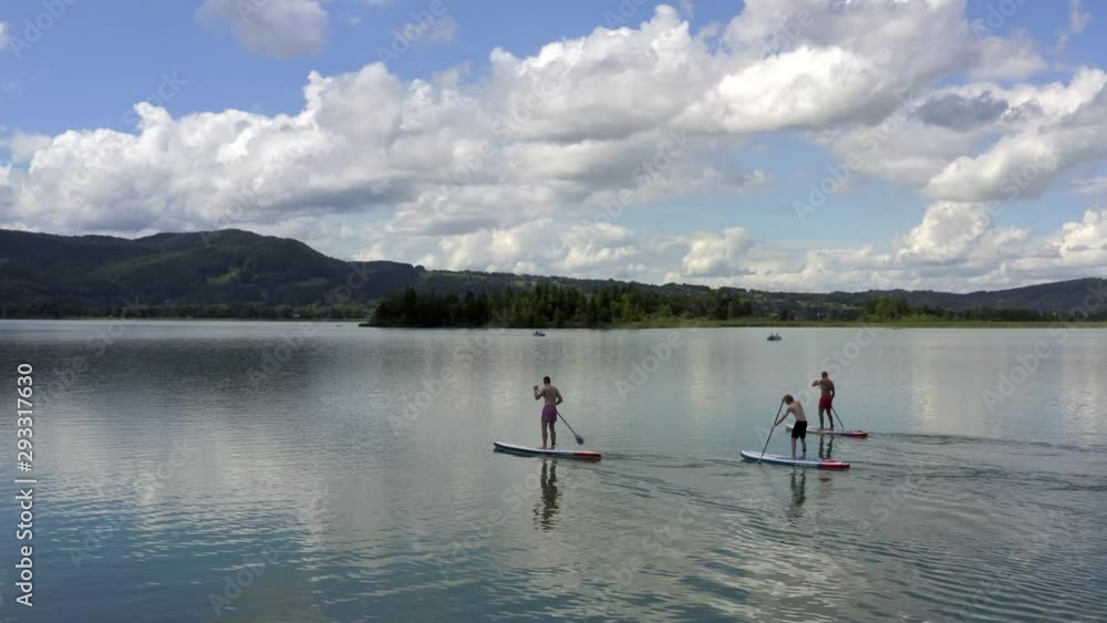 Stand-Up-Paddling on the Kochelsee near Munich, Germany at the edge of the Bavarian Alps Stand-Up-Paddling on the Kochelsee near Munich, Germany at the edge of the Bavarian Alps