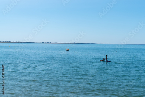 two girls on a paddle board at the edge of   le de Noirmoutier France