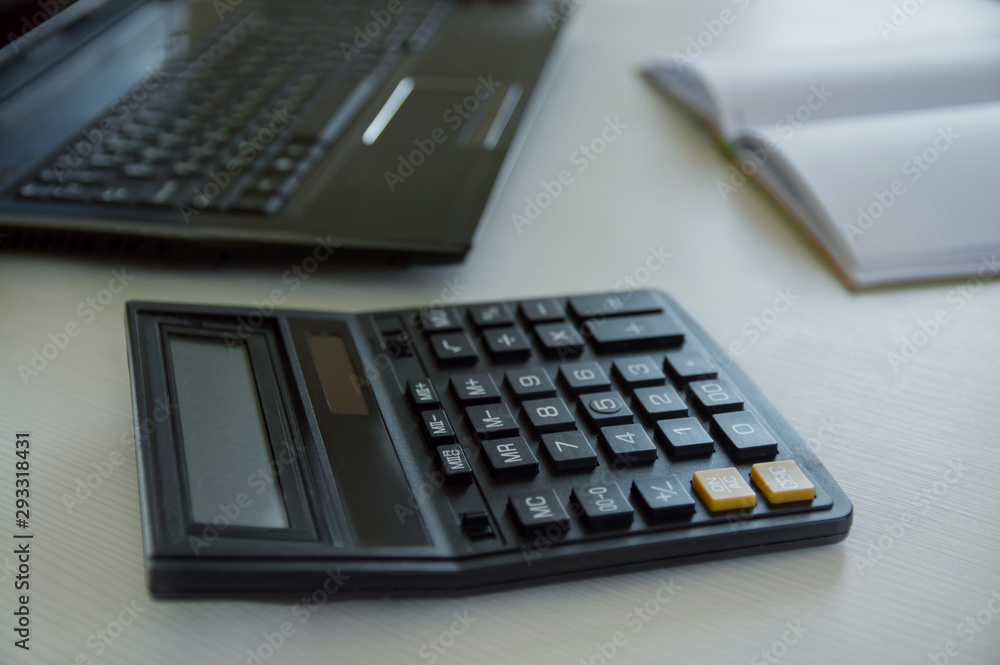 calculator and pen on table calculator and pen on table