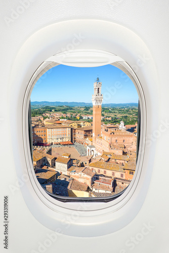 Siena seen through the window of airplane, travel in Europe concept