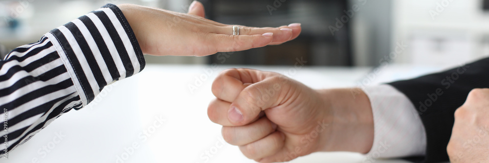 Focus on smart people hands playing child game rock paper and scissors and fooling around. Businesswoman in trendy striped blouse or shirt winning. Blurred background Focus on smart people hands playing child game rock paper and scissors and fooling around. Businesswoman in trendy striped blouse or shirt winning. Blurred background