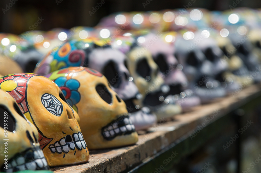Naklejka premium Mexican colorful skulls. Traditional Mexican souvenirs. The symbol of the holiday of the day of the dead. Ceramic pottery Day of the Dead, Dia de los Muertos, skulls.