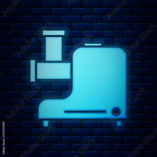 Glowing neon Kitchen meat grinder icon isolated on brick wall background. Vector Illustration