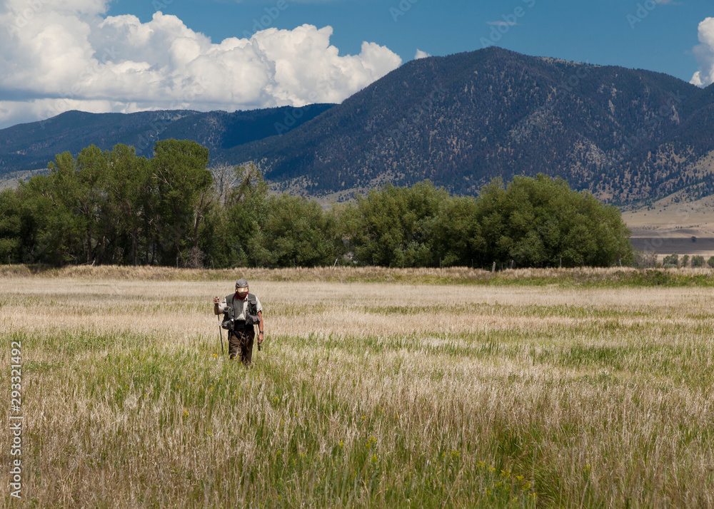fisherman walking through a field fisherman walking through a field