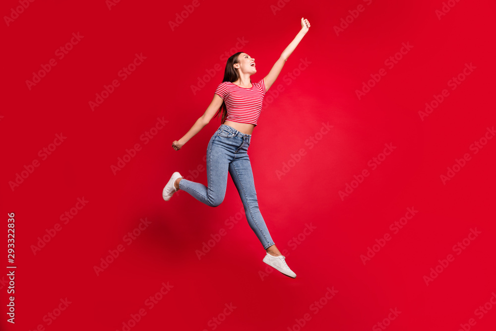 Full length body size photo of ecstatic stylish trendy beautiful charming cute lady trying to catch something while stretching isolated with red background