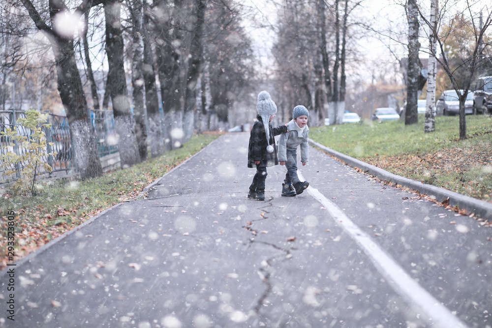 Kids walk in the park first snow Kids walk in the park first snow