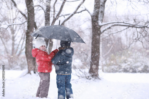 Kids walk in the park first snow