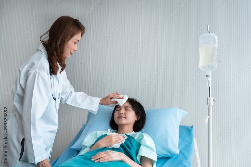 Fototapeta premium A doctor is taking care of a sick young woman with seasonal infections flu