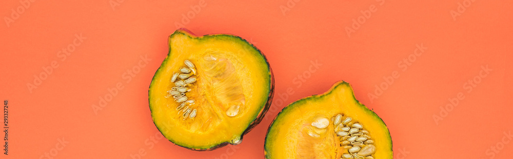 top view of yellow cut pumpkin on orange background with copy space, panoramic shot top view of yellow cut pumpkin on orange background with copy space, panoramic shot