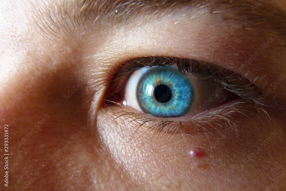 Fototapeta premium Deep blue eye watching into the abyss, blond haired