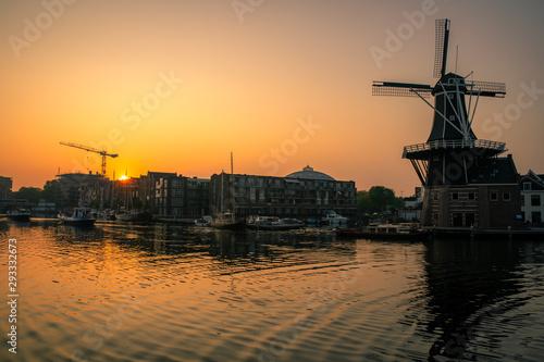 Sunrise over a canal at a windmill in the Netherlands Amsterdam