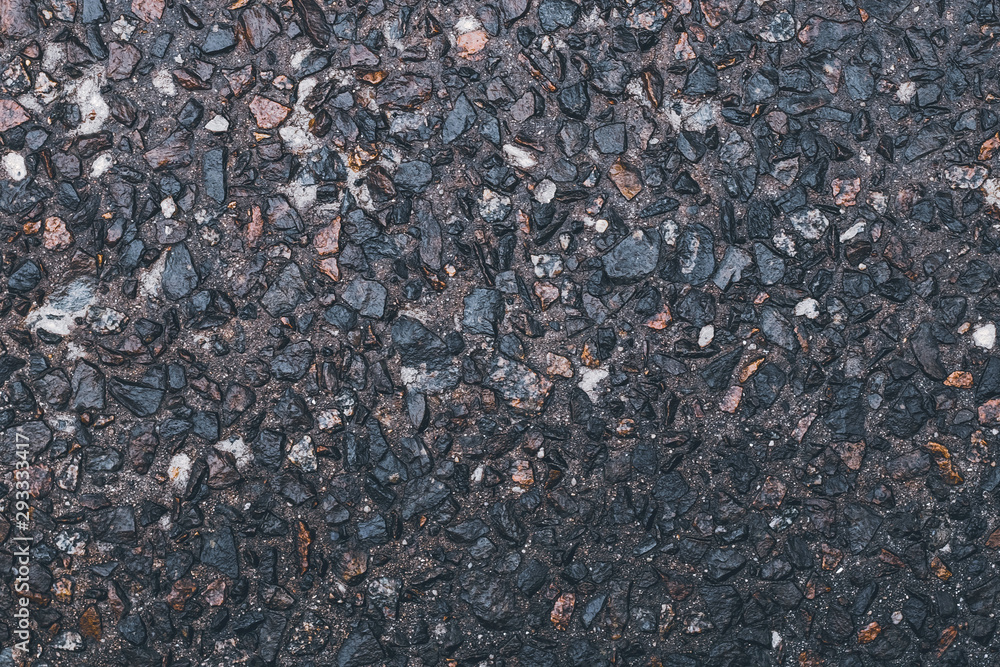 Gray stone background. Abstract pattern of gravel. Natural road texture. Rock material. Grunge floor on street. Small brown and grey pebbles. Gray stone background. Abstract pattern of gravel. Natural road texture. Rock material. Grunge floor on street. Small brown and grey pebbles.