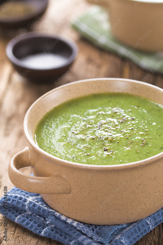 Fresh homemade cream of zucchini soup garnished with freshly ground black pepper served in bowls (Selective Focus, Focus one third into the soup) Fresh homemade cream of zucchini soup garnished with freshly ground black pepper served in bowls (Selective Focus, Focus one third into the soup)