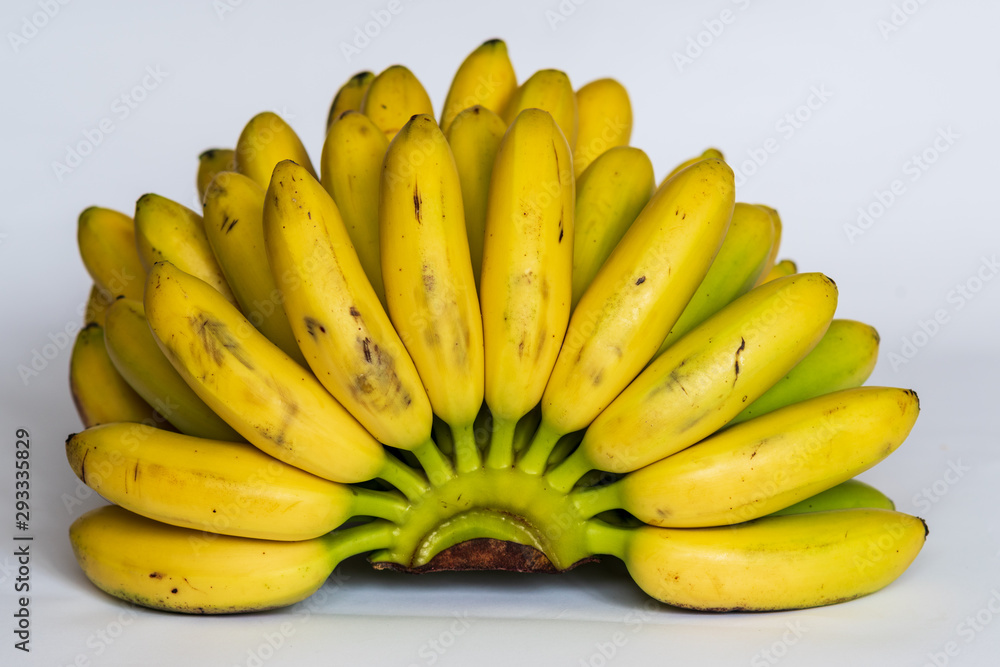 A bunch of small ripe bananas, top view, on white background