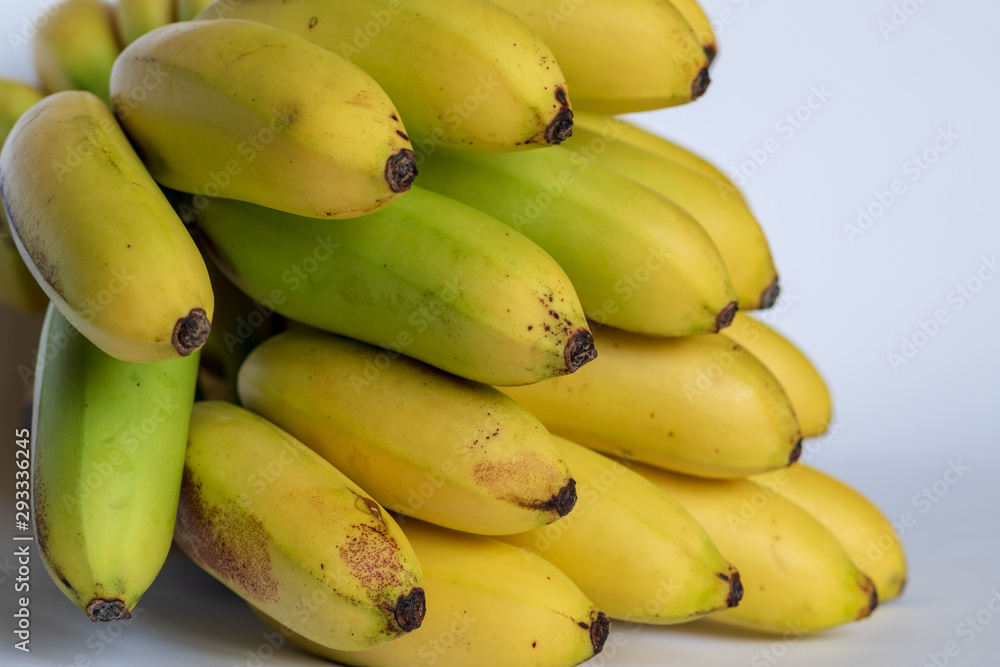 A bunch of small ripe bananas, front view, on white background