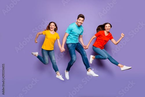 Full length body size photo of having wild mad good mood group of funny millenial person hipsters hurrying to get low seasonal sales isolated violet purple background
