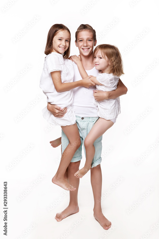 The brother holds two systricks in his hands, in the studio on a white background, everyone laughs, indulges, plays. Happy childhood. Isolated. The brother holds two systricks in his hands, in the studio on a white background, everyone laughs, indulges, plays. Happy childhood. Isolated.