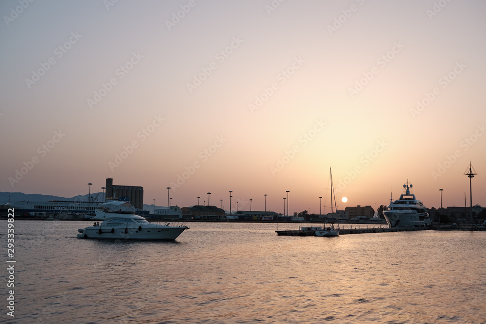 AUG 2019 Port of Cagliari at sunset with yacht and boats - Sardinia Italy.