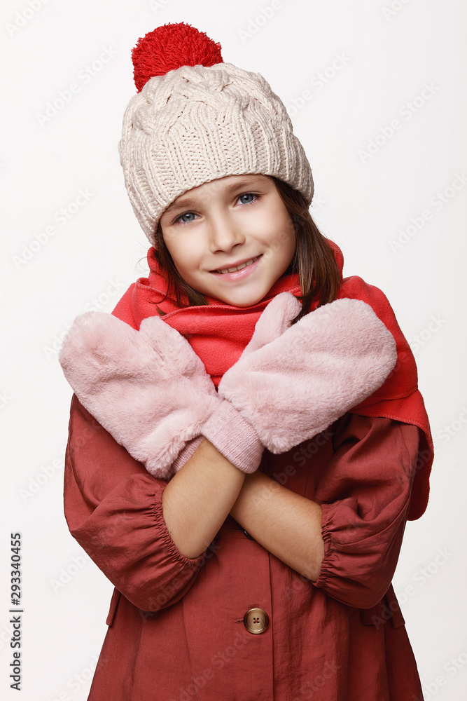 The recovering laughing girl in a jacket, a cap, gloves, a disease, cold, flu, winter, fall. Immunity. On a white background in studio. The recovering laughing girl in a jacket, a cap, gloves, a disease, cold, flu, winter, fall. Immunity. On a white background in studio.