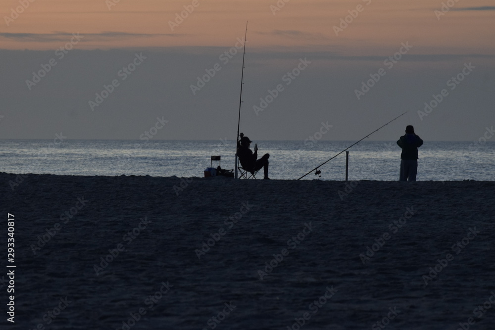 silhouette of fisherman at sunset silhouette of fisherman at sunset