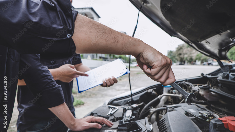 Fototapeta premium Services car engine machine concept, Automobile mechanic repairman hands repairing a car engine automotive workshop with a wrench, car service and maintenance