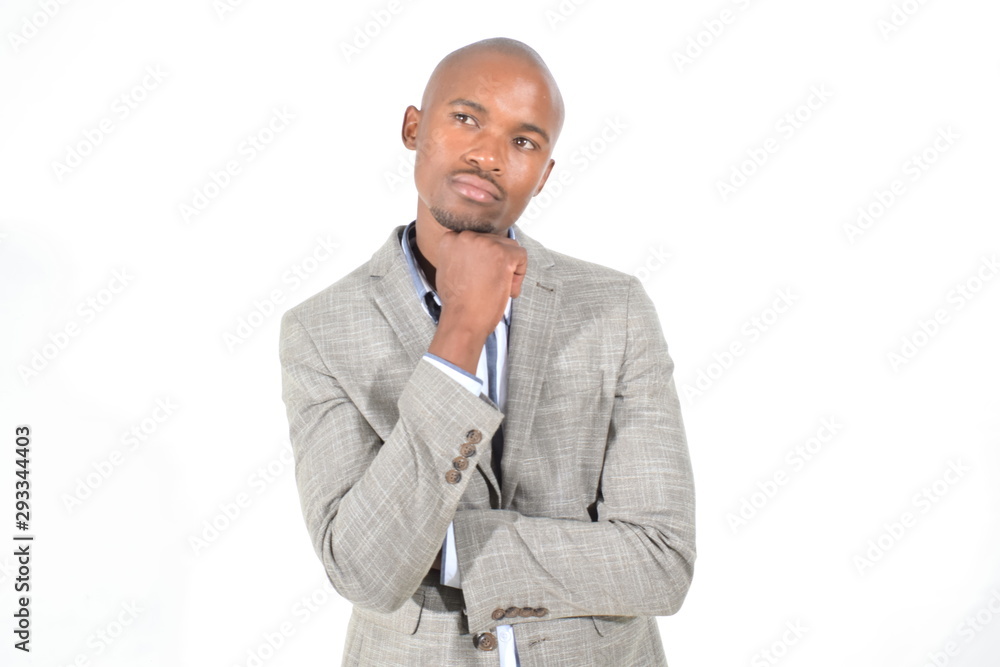 portrait of a young businessman thinking with hand on chin